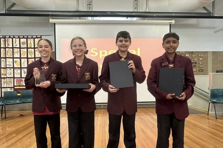 4 students holding awards
