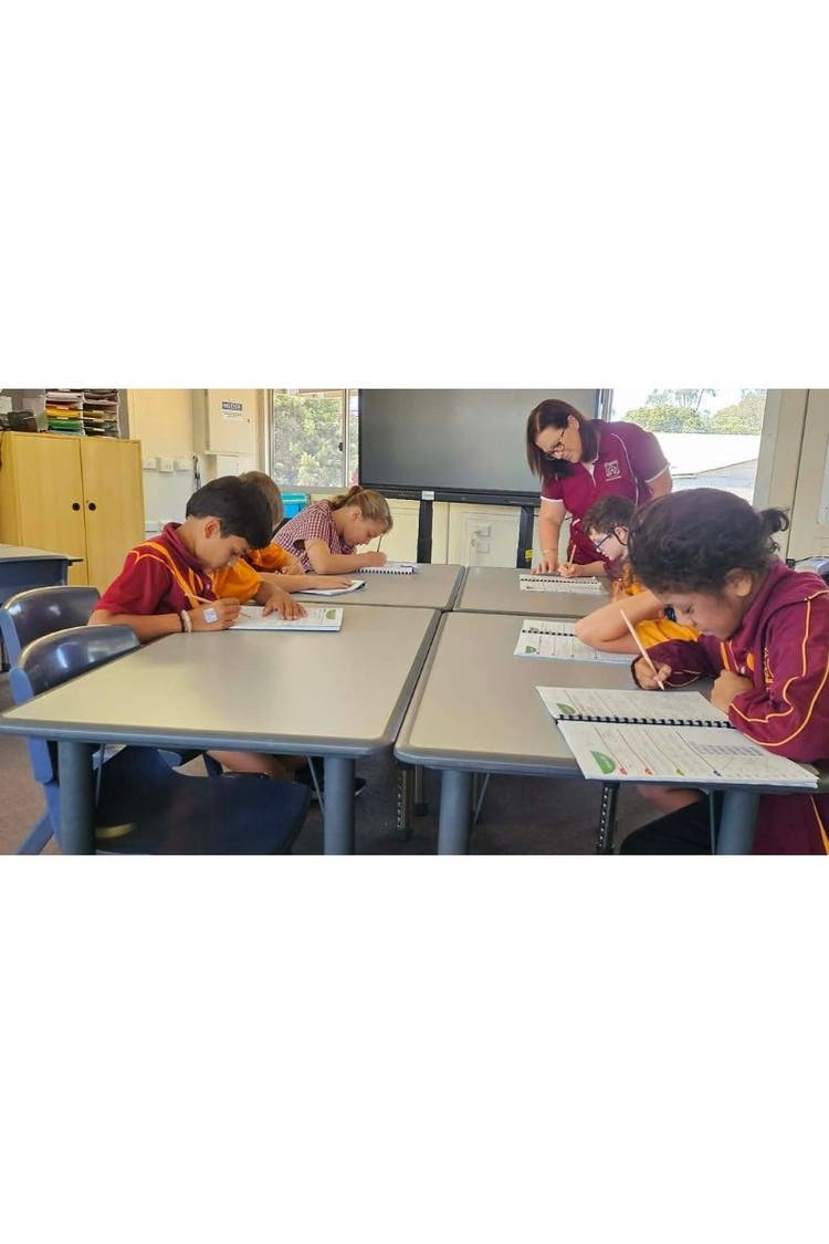 Teacher working with students in learning hub