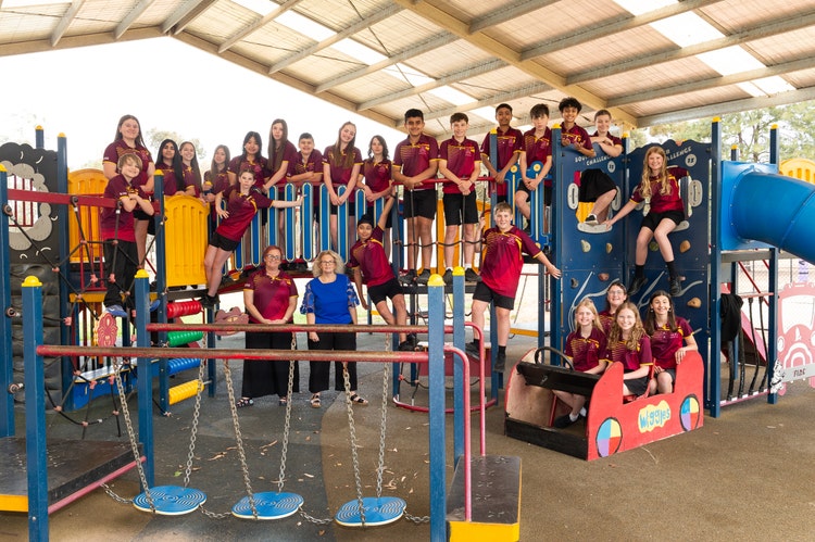Year 6, their teacher and principal on the school equipment